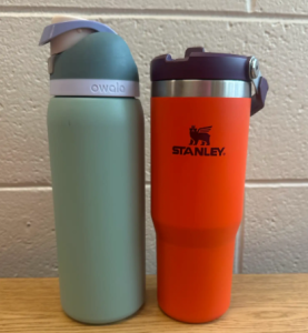 Owala water bottle (left) next to a Stanley water bottle (right)