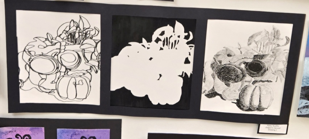 This is an example of the still life project from the Drawing One class. This shows three different types of still lifes, including contour line, negative space, and hatching. The piece shown is called "Dragon's Harvest" and was made by Ryley Nuoffer.