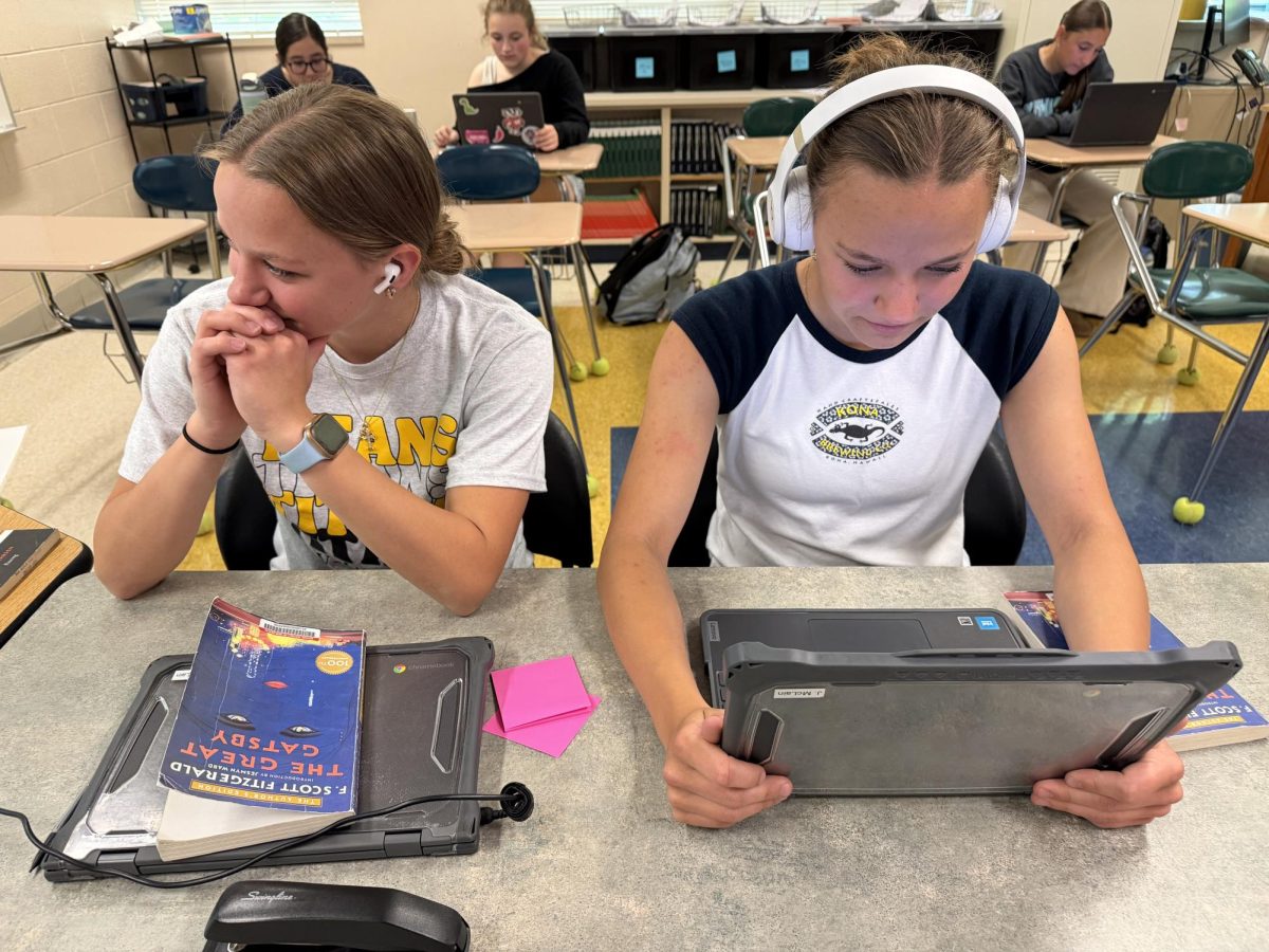 Lauren McLain (left) wearing Airpods and Julia McLain (right) wearing Beats.